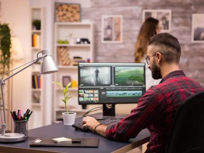 back-view-creative-filmmaker-working-movie-laptop-girlfriend-background