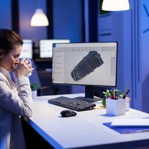 woman-engineer-working-late-night-3d-model-industrial-turbine-while-drinking-coffee-front-computer
